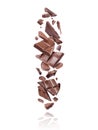 Broken bars of dark chocolate fall down on white background