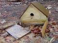 Broken Birdhouse Against The Dead Leaves Royalty Free Stock Photo