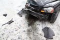 Broken black car on road in winter