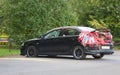 A broken black car is sealed with red sticky tape Royalty Free Stock Photo