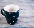 Broken black ceramic cup, blue wooden background, free space Royalty Free Stock Photo
