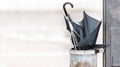 Broken black umbrella thrown into trash on a street Royalty Free Stock Photo