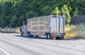 Broken blue big rig semi truck with an open hood stands out of the road with emergency stop signal with semi trailer for