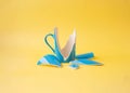 A broken blue cup with shards around on a yellow background Royalty Free Stock Photo