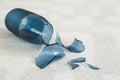 Broken blue glass vase on carpet, closeup Royalty Free Stock Photo