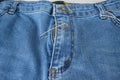 Broken blue jeans zipper fixed with safety pin. Royalty Free Stock Photo