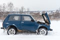 Broken blue Russian off-road car Lada Niva 4x4 VAZ 2121 / 21214 parked with an open bonnet