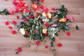 Broken bouquet of roses, scattered on the floor, concept of mother`s, Valentine`s day, birthday, mercantile love of money,