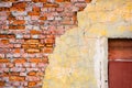 Broken brick wall with cracked plaster and a boarded up window Royalty Free Stock Photo