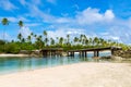 Broken bridge under palm trees between islets over lagoon, North Tarawa atoll, Kiribati, Micronesia, Gilbert islands, Oceania,