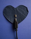 Connectivity issue with broken cable and leather heart on blue background Royalty Free Stock Photo