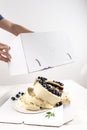 Broken cake inside the box on white background. Bad delivery concept. Spoiled birthday, wedding. Bad luck. Copy space Royalty Free Stock Photo