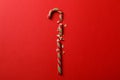 Broken candy cane on red background