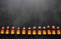 Broken candy corn look like small bad teeth. Black background. Copy space. Halloween harmful sweets concept Royalty Free Stock Photo