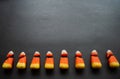 Broken candy corn look like small bad teeth. Black background. Copy space. Halloween harmful sweets concept Royalty Free Stock Photo