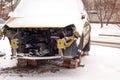 Broken car after an accident under the snow. Consequences of violation of traffic rules