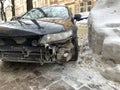 Broken car on the background of a snowdrift. Passenger car without front bumper. Concept: extreme driving in winter