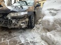 Broken car on the background of a snowdrift. Passenger car without front bumper. Concept: extreme driving in winter