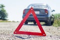 Broken car concept, breakdown triangle on road. Sign of emergency stop car on the road. Broken down car dangerously parked awaitin Royalty Free Stock Photo