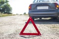 Broken car concept, breakdown triangle on road. Sign of emergency stop car on the road. Broken down car dangerously parked awaitin Royalty Free Stock Photo