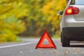 Broken car concept, breakdown triangle stop sign on road Royalty Free Stock Photo