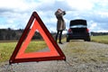 Broken car, girl and warning triangle