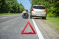 Broken car and male driver changing the wheel Royalty Free Stock Photo