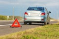 Broken car with red triangle sign.