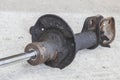 broken car shock absorber soiled with fuel oil on the concrete floor Royalty Free Stock Photo