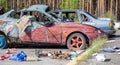 Broken car after a traffic accident in the parking lot of a repair station.