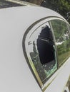 Broken car window on a white car during the day Royalty Free Stock Photo