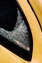 Broken car window and cracked glass of a automobile following attempted theft