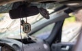 Broken car windshield from a bullet, inside view. Damaged glass with traces of an oncoming stone on the road. Interior view of the