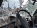 Broken car windshield. Exploded transport on the background of the house. The car was damaged in the war
