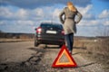 Broken car - woman driver pulled over on a country road Royalty Free Stock Photo