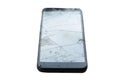 Broken Cellular Telephone. A Cellular Telephone with a cracked and broken Screen on a white plate on a table. Broken Cell Phone Royalty Free Stock Photo