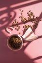 Broken ceramic cup and coffee beans in harsh shadows. Monochrome vertical photography