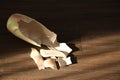 Broken ceramic vase on wooden floor, above view. Space for text