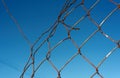 Broken Chain Link Wire Mesh Fencing with Blue Sky Royalty Free Stock Photo