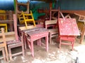 broken chairs and tables are unused and piled