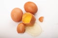 Broken chicken egg and eggs scattered on a white background. Close up Royalty Free Stock Photo