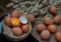 Broken chicken egg over Fresh chicken eggs Hen eggs placed on small timber and Dried flowers on Black floor Royalty Free Stock Photo