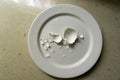 Broken chicken egg shell on a plate Royalty Free Stock Photo