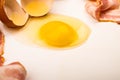 A broken chicken egg and sliced bacon on a white background. Close up Royalty Free Stock Photo