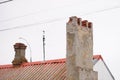 Broken chimney on an old red roof of asbestos cement Royalty Free Stock Photo