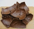 Broken chocolate Easter egg on a wooden table Royalty Free Stock Photo