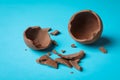 Broken chocolate egg on light blue background Royalty Free Stock Photo