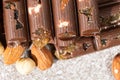 Broken chocolate pieces with nuts and raisins on a stone background top view Royalty Free Stock Photo