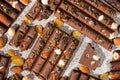Broken chocolate pieces with nuts and raisins on a stone background top view Royalty Free Stock Photo