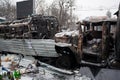 Broken and completely burned cars and buses on the massive barricades of occupying snow city during anti-government protest